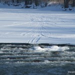 Snowmobile tracks into open Water